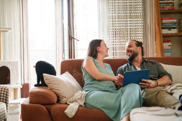 istock Expectant Family using digital tablet in living room 1493008817