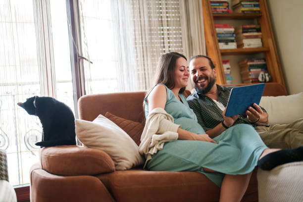 istock Expectant Family using digital tablet in living room 1493009041
