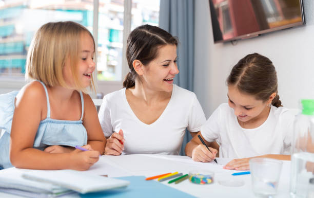 istock Young woman and two daughters drawing together 1493013981