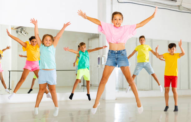 istock Group of cheerful tweens jumping during dances class 1493014211