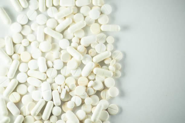 istock White pills laid out on a light gray surface. 1493014417