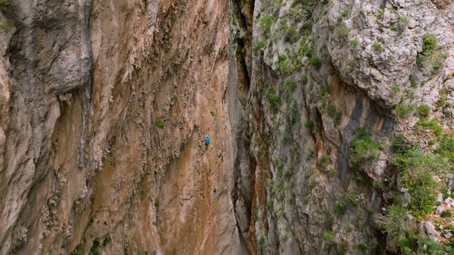 Aerial view of epic Adventurer Extreme Sport Rock Climbing Man, Epic Adventurer Extreme Sport Compound, Mountaineer,Man rock climbing, climbing cliff face