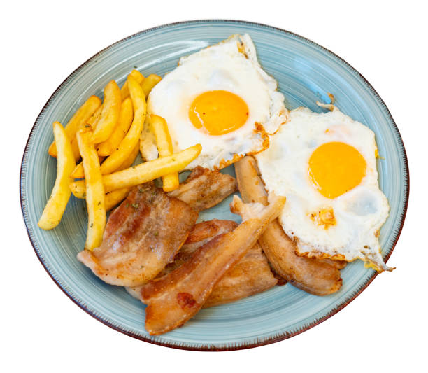 istock Fried eggs with bacon slices and fries for breakfast 1493015981