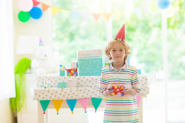 istock Kids birthday party. Child opening present. 1493019030