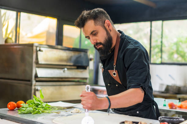 istock Chef is preparing vegan pizza at restaurant 1493024066