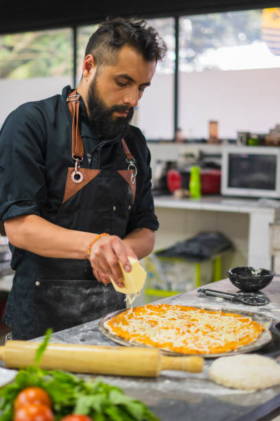 istock Chef is making vegan pizza at restaurant 1493024097