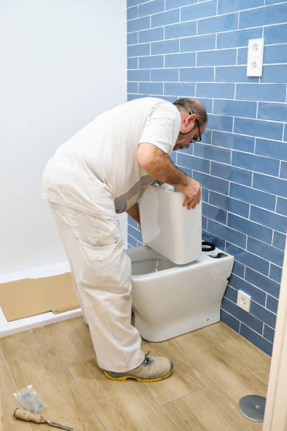 istock Senior plumber installer installing toilet cistern. 1493026935