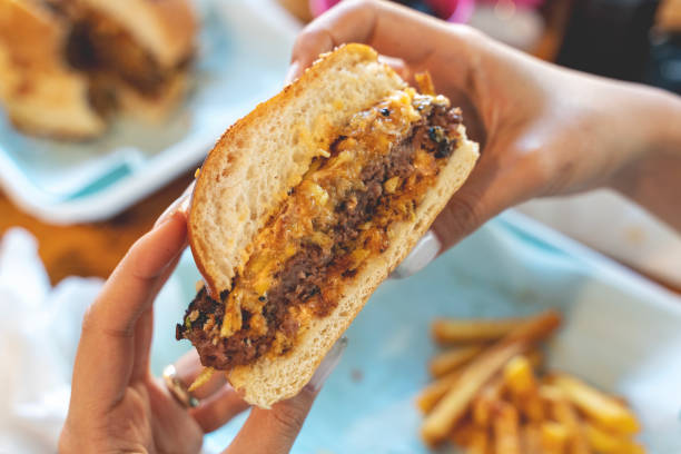 istock Woman eating beef burger 1493036388