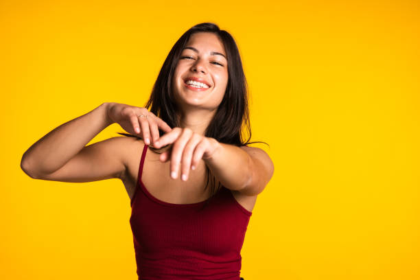 istock Cheerful Eurasian woman posing against yellow backdrop. 1493036549
