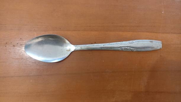 istock metal spoon on a wooden surface, closeup 1493041032