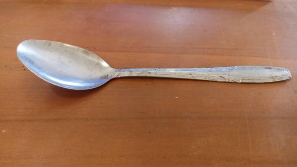 istock metal spoon on a wooden surface, closeup 1493041036