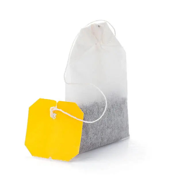 Teabag with yellow label. Isolated on white background