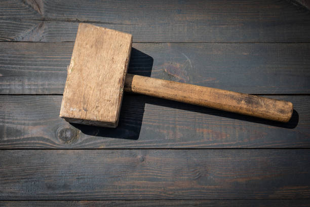 istock Old wooden carpenter's hammer on dark wood texture background 1493045185