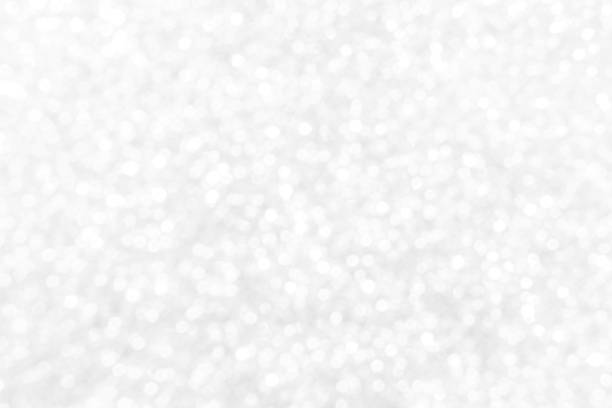 istock White and gray bokeh glitter sparking light background. 1493049989