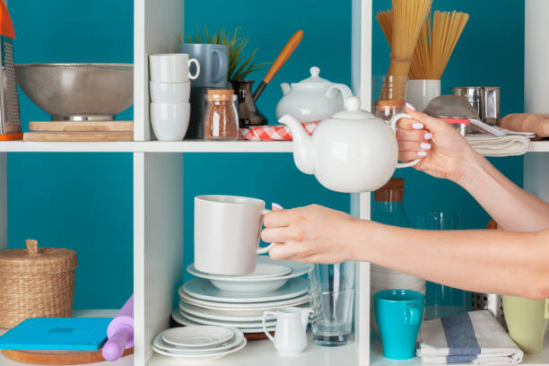 istock Hand of a woman taking kitchenware from a kitchen shelf 1493051839