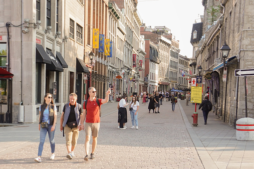Montreal, Quebec, Canada - May 24, 2023: Tourists Walking at Old Montreal in a Sunny Day.