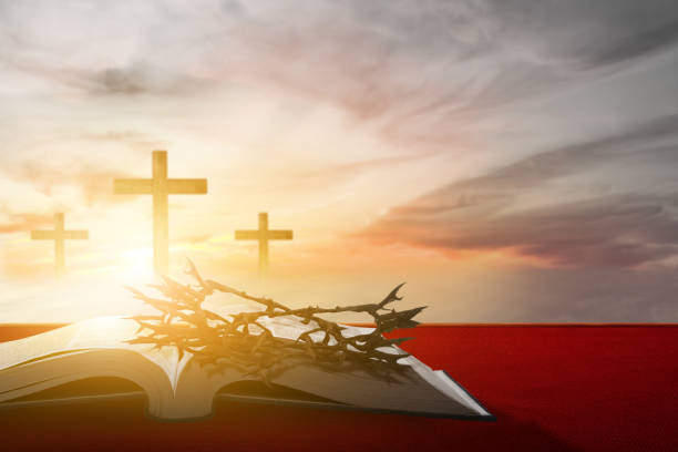 istock Christian Cross and open book with a crown of thorns 1493059456