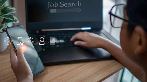 istock Human holding  smart phone and using computer laptop to job search on online internet. applying for a job concept. 1493060480