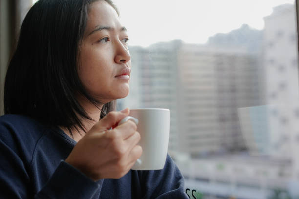 istock woman drinking coffee by the window 1493067359