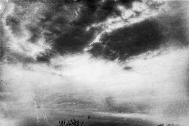 istock A black-and-white abstract photograph depicts a dark sky and cloudy landscape as a massive whirlwind sweeps away dust and dirt. 1493071200