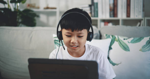 istock Cute boy enjoy to learning playing piano at home 1493073895