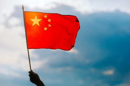 Optimistic person holding national flag celebrating Chinese culture