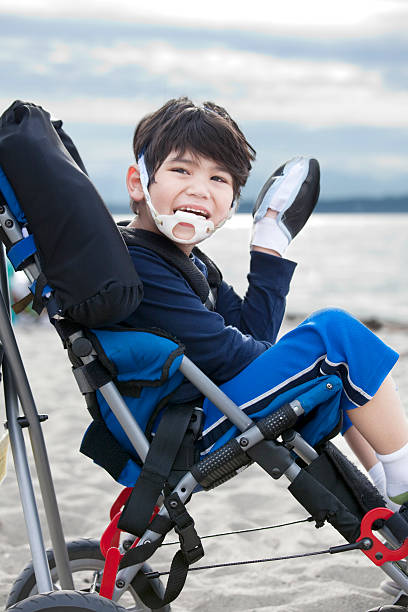 istock Happy disabled boy in wheelchair on the beach 149307561