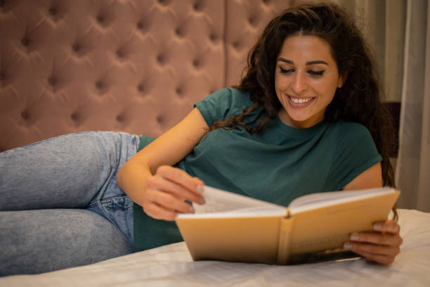 istock Woman relaxing and reading a book 1493080513