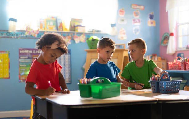 istock Three kids actively learning and playing in a nurturing daycare environment 1493080770