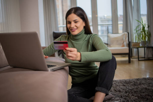 istock Woman using her credit card to shop online 1493080949