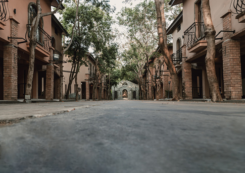 Nakhonsawan, Thailand - Apr 23, 2023 - Architecture Exterior of Walkway between Vintage Lodgings to Beautiful Historic Brick Building. Art and Architecture Concept, Copy space, Selective focus.