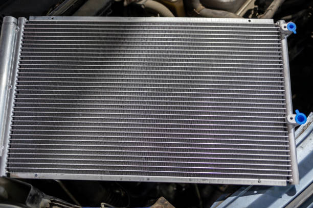 Texture of a car radiator. Engine cooler background. Vintage style. Radiator grille for car interior heater air conditioner, close-up. Radiator repair and replacement.