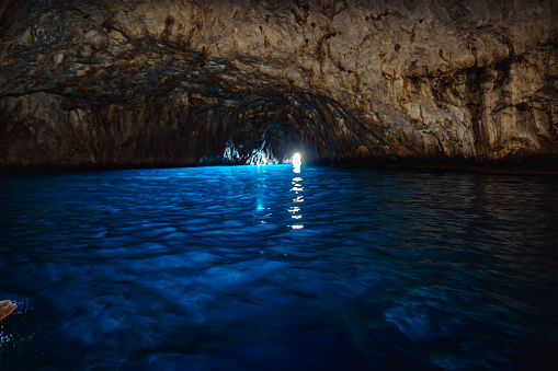 The Blue Grotto, or Grotta Azzurra in Italian, is a famous sea cave located on the island of Capri in Italy. It is one of the most popular tourist attractions in the region and has been attracting visitors for centuries.

The Blue Grotto is known for its mesmerizing blue light, which is created by the sunlight passing through an underwater cavity and reflecting off the cave's limestone walls. This phenomenon gives the cave a magical and ethereal atmosphere.

To enter the Blue Grotto, visitors must board small rowboats, known as 