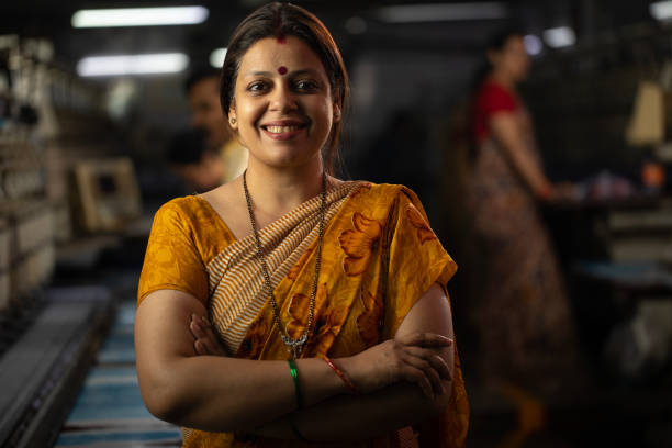 An Indian woman wearing her silver Payal (anklets) on foot decorated with Mehndi (Henna).