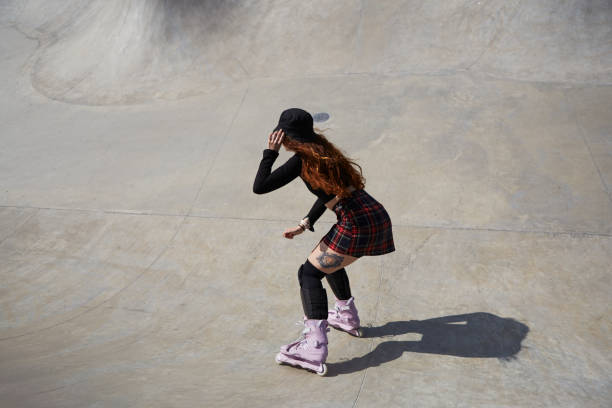 istock Roller blader female skating in a concrete pool. Aggressive inline skater chick riding in a skatepark in summer 1493093335