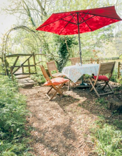 istock Outdoor setting with a table and two chairs, with a bright umbrella 1493095360