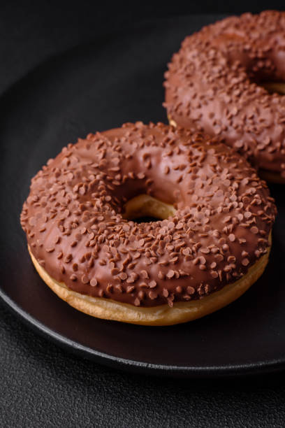 istock Delicious chocolate glazed donut sprinkled with chocolate chips 1493096538
