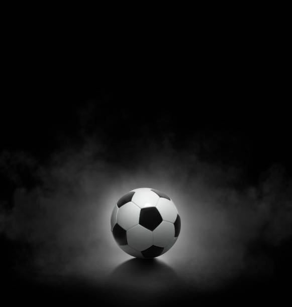 istock Soccer ball with on black background with smoke 1493098910