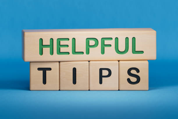istock Helpful tips symbol. Books with words 'Helpful tips'. Beautiful wooden table, white background. Business and helpful tips concept. Copy space. 1493102513