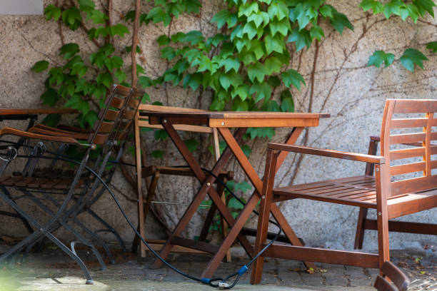istock chairs and tables in front of a house wall 1493105272