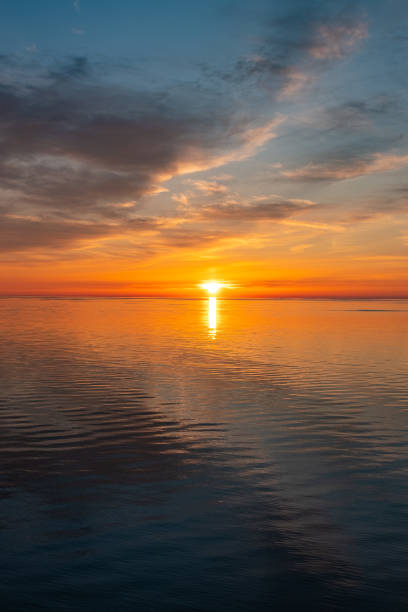 istock Seascape. Bright sunset on the sea, cloudy blue sky. 1493105444