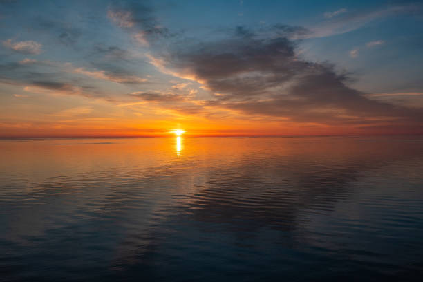 istock Seascape. Bright sunset on the sea, cloudy blue sky. 1493105514