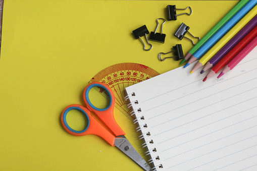some school supplies on a yellow background