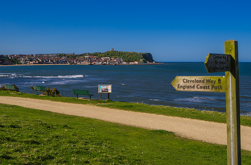The path down to the South Bay in Scarborough passes a signpost for the Cleveland Way and English Coast Path.