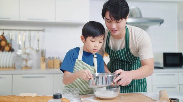 istock Asian single father teaching son cooking or baking spending time on holidays together in kitchen room at home. Food and cuisine concept, Happy asian family 1493115221