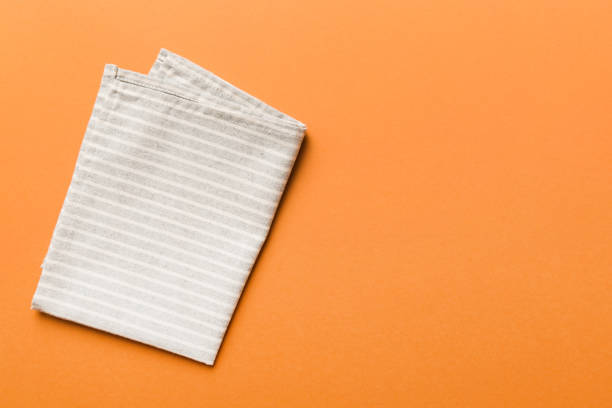 istock top view with gray kitchen napkin isolated on table background. Folded cloth for mockup with copy space, Flat lay. Minimal style 1493119973
