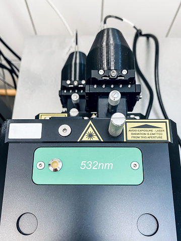 Lasers in a research facility connected to a Raman microscope-spectroscope. Safety symbols are visible.