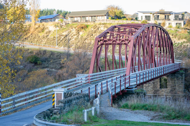 Clyde, New Zealand: A magnificent bridge spans the Clyde River, creating a captivating sight in the scenic landscape.