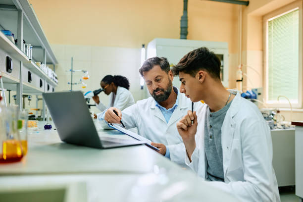 istock Medical laboratory scientist and his colleague cooperating while analyzing research data. 1493124988