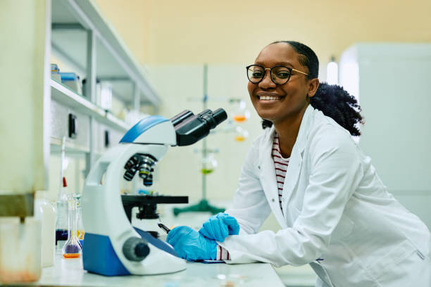 istock Happy black female scientist in laboratory looking at camera. 1493125055